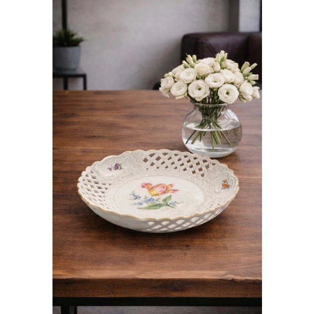Elegant vintage porcelain bowl crafted by Meissen, Germany, circa 1970. This refined reticulated (pierced) model features...