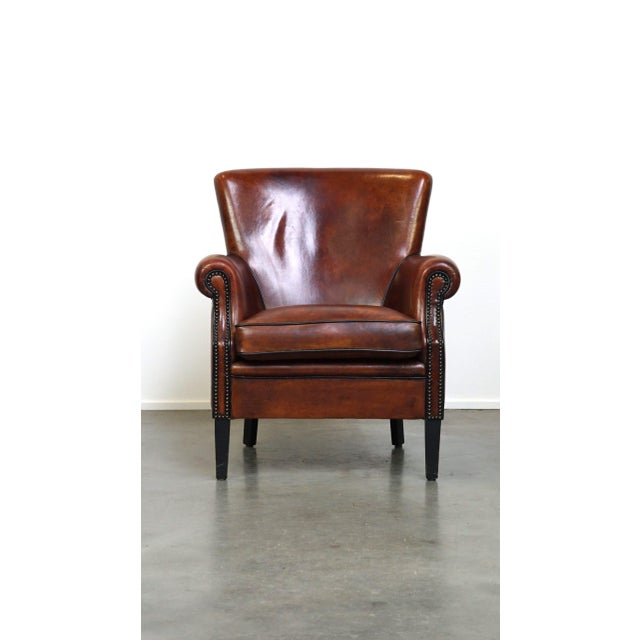 This charming sheepskin armchair exudes charm with its unique and familiar look. The armchair features a loose seat...