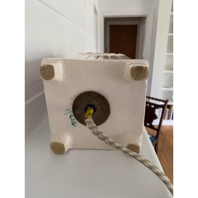 White with burgundy flowers and designs. Each lamp is marked on the bottom with a number and “Italy”. One has a small chip...