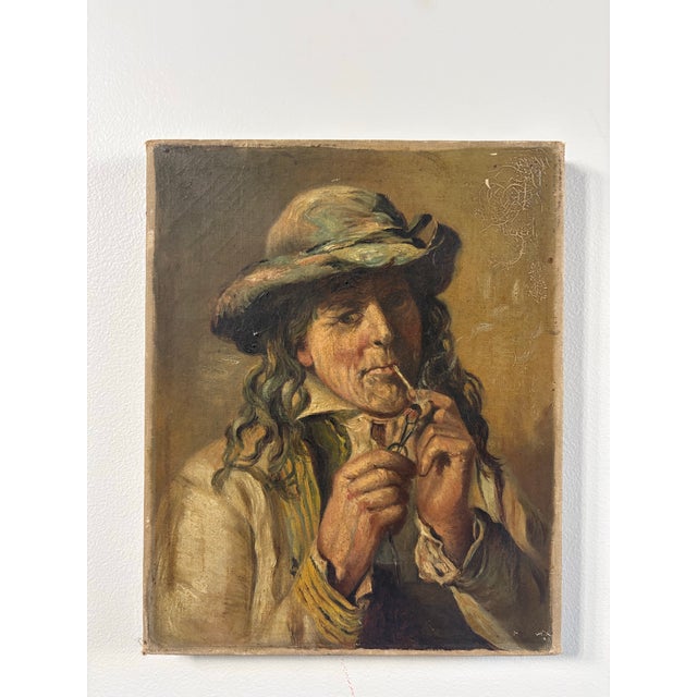 This is a really soulful 19th-century oil on canvas portrait of a man in a hat with a pipe. It’s a classic character study...