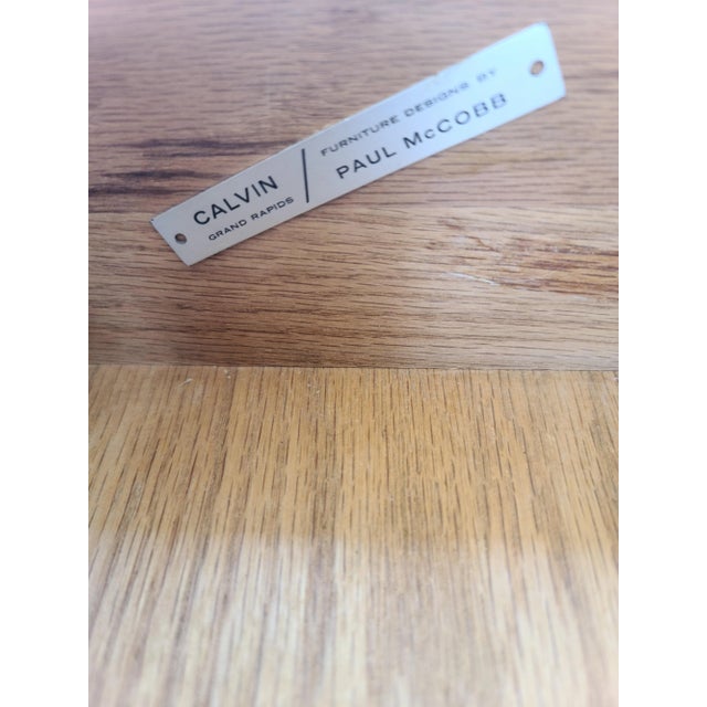 Designed by Paul McCobb and manufactured by Calvin Furniture, this four-drawer dresser features aluminum accents and...