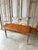 Mid-20th century directoire-style flat desk in cherry wood. Camel leather top embossed with a pattern around the edge....
