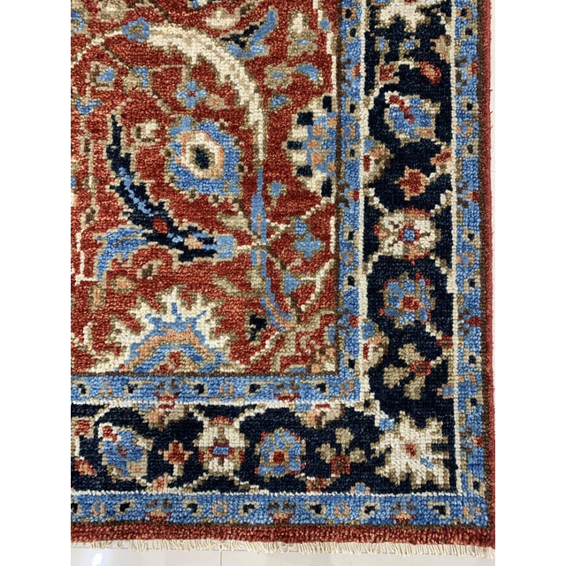 A hand-knotted wool rug in a rustic Oriental style, made in India and measuring 9' x 12'. The drawing is tribal and...