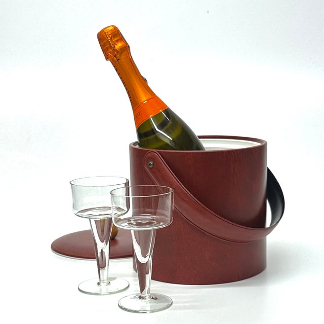 Maroon ice bucket.&nbsp; This gorgeous maroon cylindrical ice bucket by Georges Briard features a padded faux-leather...
