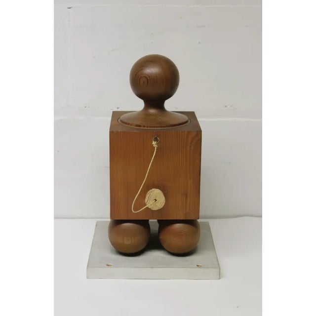 Wood block-form vessel with cylindrical plunger and cork stopper.