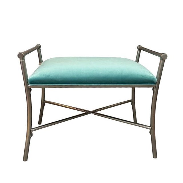 A modern-style bench with a sleek chrome frame. This bench has a minimalist design, featuring straight lines and simple...