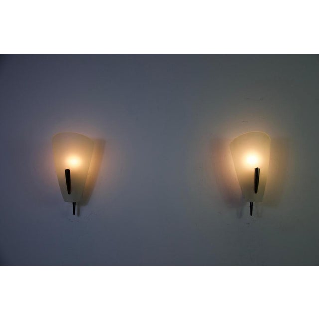 Pair of mid-century brass and glass wall lamps by stilnovo, italy, 1960s. This elegant set features softly curved opaline...