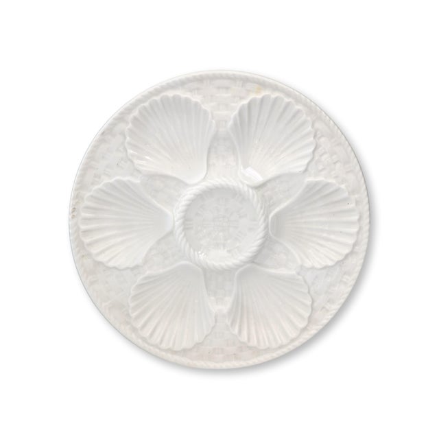 Set of six midcentury Longchamp oyster plates in creamy white faience, c.1940s–1960s. Each plate is molded with six shell-...