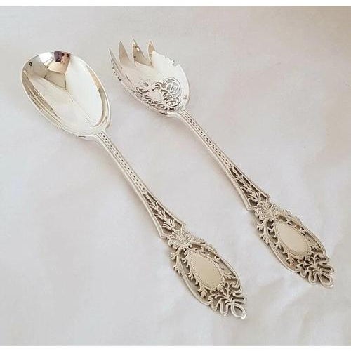 A fine pair of George V sterling silver serving pieces, hallmarked London 1930 and made by **Josiah Williams & Co.**...