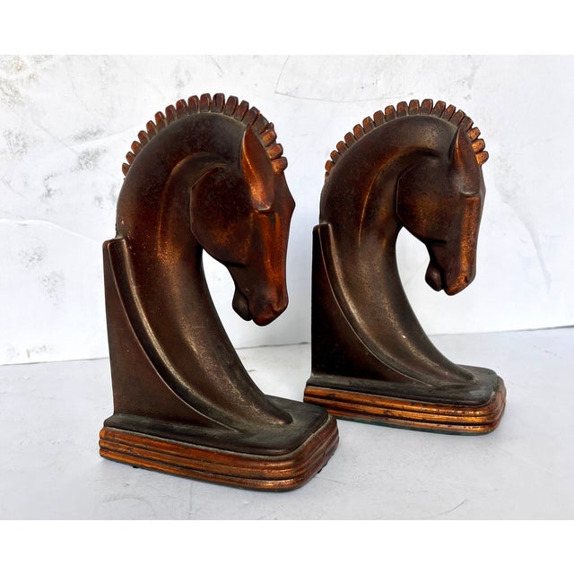 Vintage 1930s art deco style cast metal bookends with bronze and copper finish. Majestic Trojan horse heads manufactured...