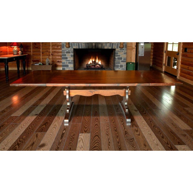Beautiful craftsmanship and high quality trestle table made by Ethan Allen. Really great wood tones that complements many...