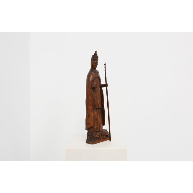 An expressive 18th‑century carved wooden figure representing Saint Cornelius, depicted in full papal regalia. The saint...