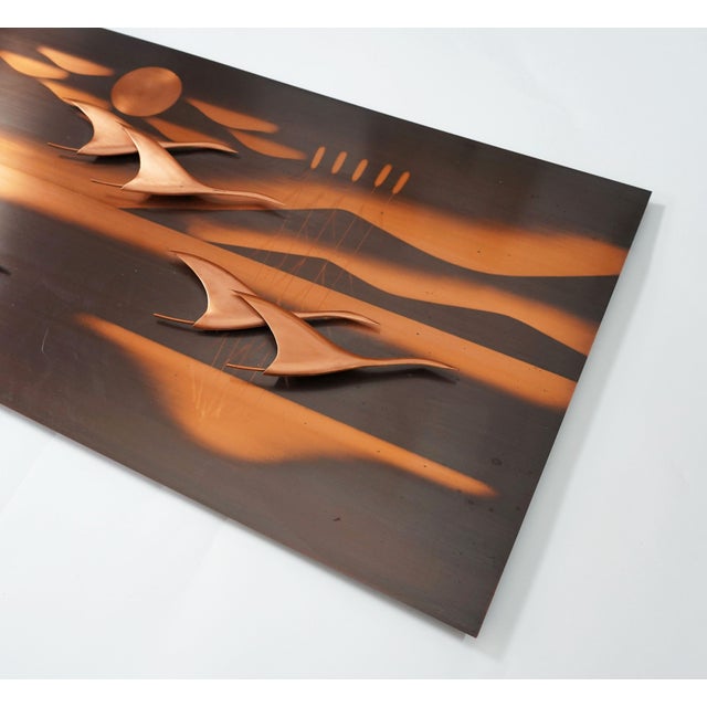 Very beautiful and decorative mid century copper wall panel with a stylized depiction of flying birds in the sun. 1950s....