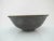 Beautiful Asian studio pottery bowl in dark gray tone with gold metallic rim and lustrous dainty flower design at center....