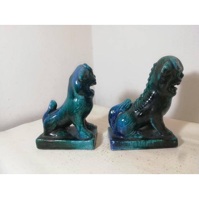 Beautiful and distinctive pair of ceramic Pho dogs, originally made in Italy by Marcello Fantoni. Marked under the base....