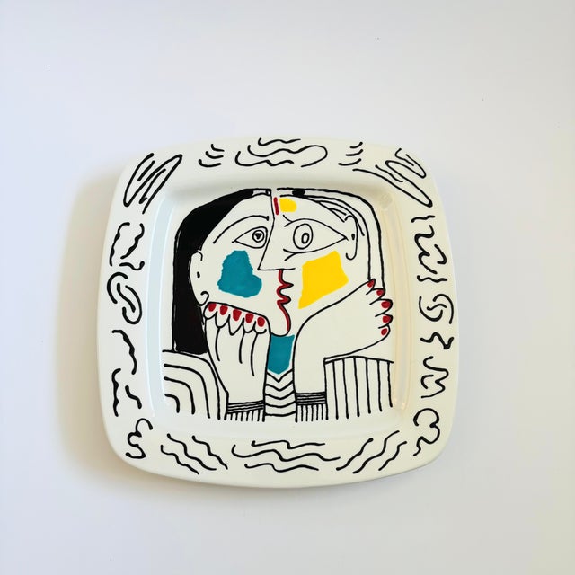 A vintage Pablo Picasso reproduction ceramic plate featuring the image from his 1962 painting "Téte Appuyée Sur Les Mains...