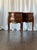 This elegant pair of French Louis XV-style nightstands features beautifully shaped bombe fronts, cabriole legs, and warm...