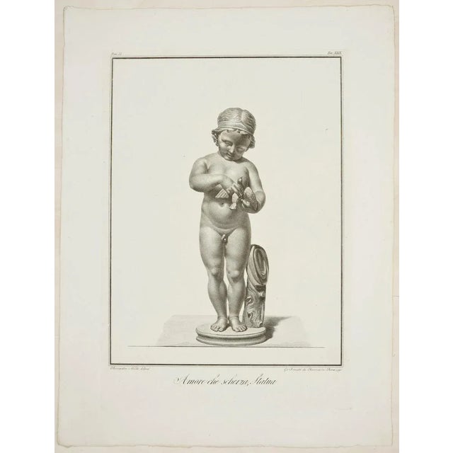 “amore che scherzo, statua” (joking eros, statue) is a wonderful black and white etching on paper, realized by the artist...
