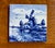 This is a charming vintage hand-painted Delft style ceramic tile featuring a traditional Dutch windmill landscape in...