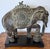 This Indian-style ornate resin elephant figure features intricate details and stands on a wood pedestal base. It measures...
