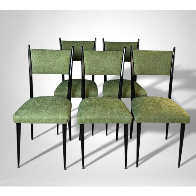 Elegant set of six ebonized wood chairs, featuring seats and backrests upholstered in a cotton and polyester fabric. The...