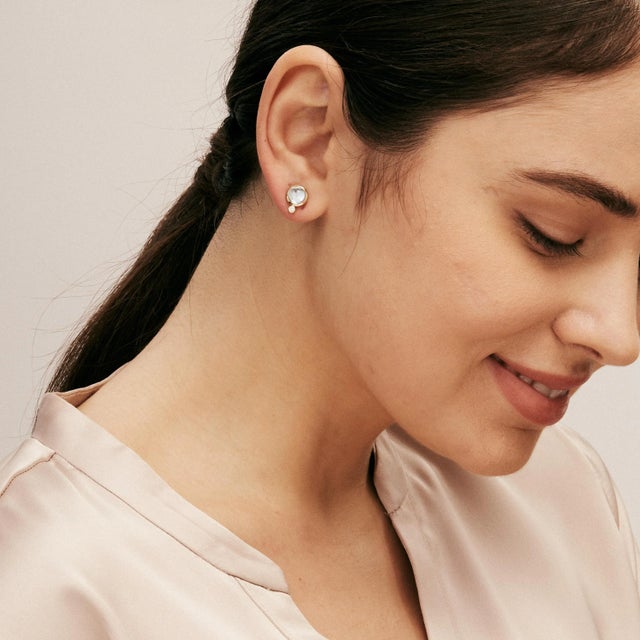 Created in 18 karat yellow gold Blue topaz 3 carats approx. Champagne diamonds 0.05 carat approx. Post backs for pierced...