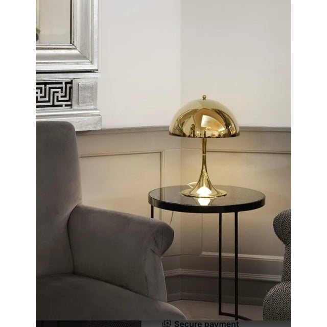 Brand new Panthella 320 table lamp by Louis Poulsen in a refined metalized brass finish, still in original packaging....