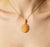 Material: 14K Yellow Gold Stone: Genuine Oval Coral Design: Angel with Floral Motif in Filigree Setting Dimensions: 32 mm...