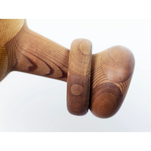 Vintage folk art turned wood sculpture crafted from Florida Heart Pine with a curiously executed free-floating wooden ring...