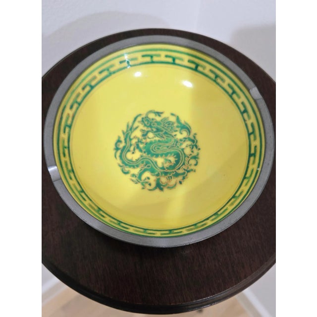 This unique bowl combines classic porcelain with vibrant cloisonné enamel work, featuring a striking green dragon motif in...