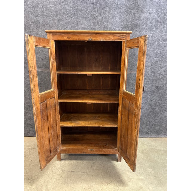 Bring organic warmth and functional charm to your space with this beautiful vintage solid wood cabinet. Crafted with a...