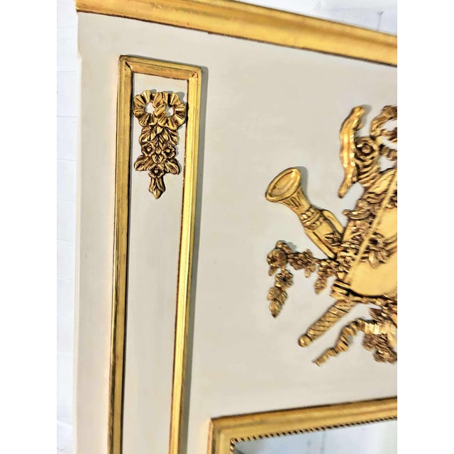 A monumental French Louis XVI style trumeau mirror of exceptional scale and presence, beautifully decorated with a...