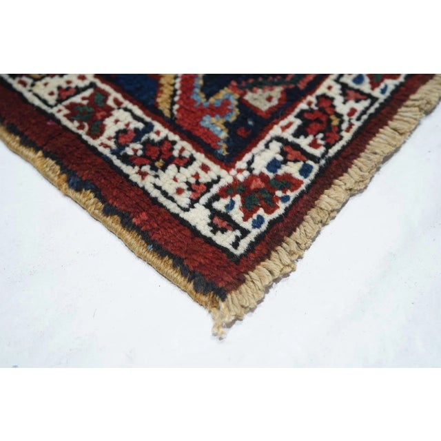 The ivory field reveals itself in the corners with quarter sub-medallion insets, and is mostly covered by he red...