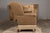 A vintage English wingback loveseat / settee with brown upholstery, out-scrolling arms and casters. This vintage English...