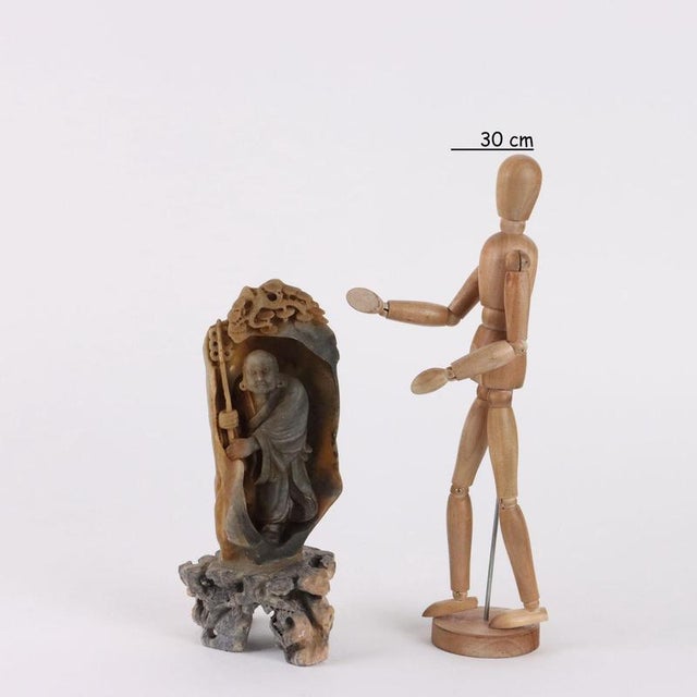 Lohan soapstone figure. The figure represented in a standing position with a sistrum in his hands as he emerges from a...