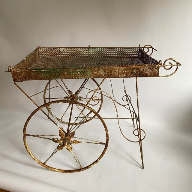 Wonderful vintage rustic metal flower cart. Having two wheels and mesh top