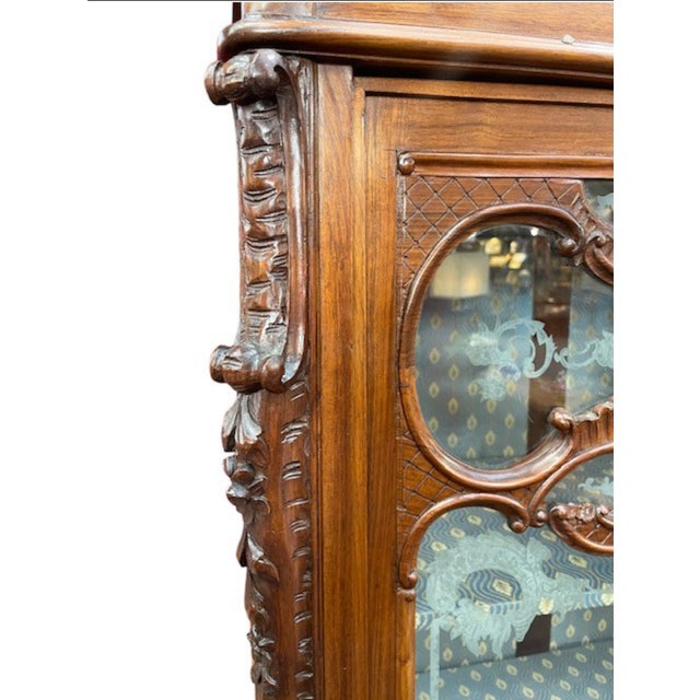 Two-door display cabinet from the early 1900s, Italian Art Nouveau period, in carved walnut wood. Original blown glass...