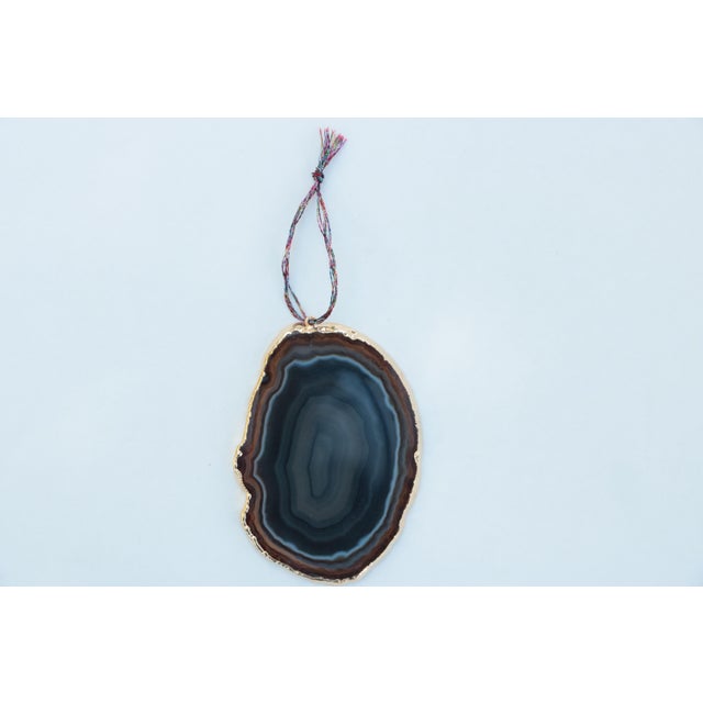 Set of six ornaments crafted from gold electroplated agate slices suspended from jewel tone metallic cord. Sizes, forms,...