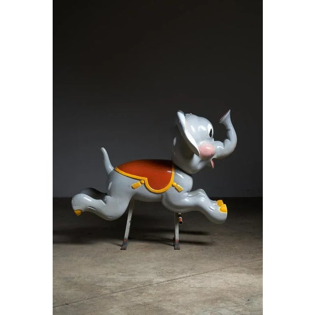 Immerse yourself in the enchanting world of antique carousels with this carved wooden elephant figure. Mounted on a metal...