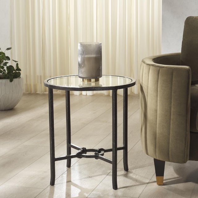 Discover the perfect blend of modern design and timeless elegance with the Tauri forged metal round accent table. The...