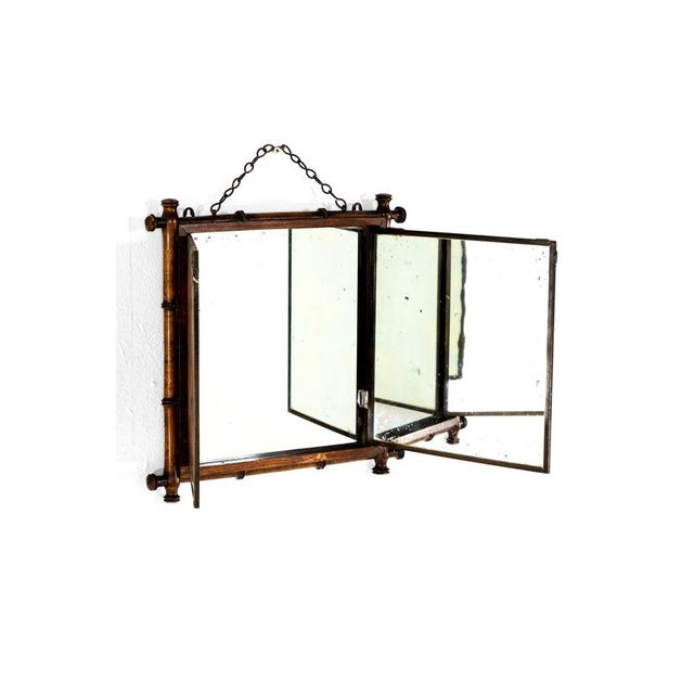 A 19th century Victorian Chinoiserie Triptych Mirror with gently foxed mirror plates inside a faux bamboo frame. In the...