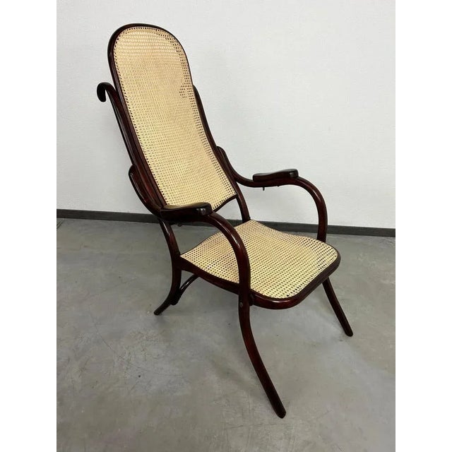 Very rare folding easy chair no.1 by Thonet professionally stained and repolished with new handmade rattan seat. This...