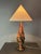 A striking sculptural table lamp from 1960s France, hand-turned from a single dense burl wood trunk. The form follows the...