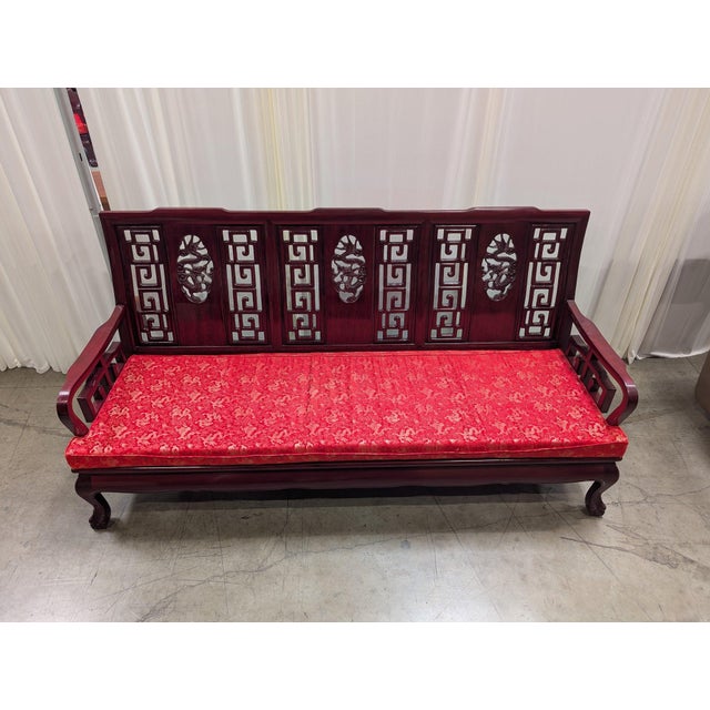 Vintage Chinese solid rosewood three-seat sofa with three hand-carved, pierced dragon medallions set into a key-fret...