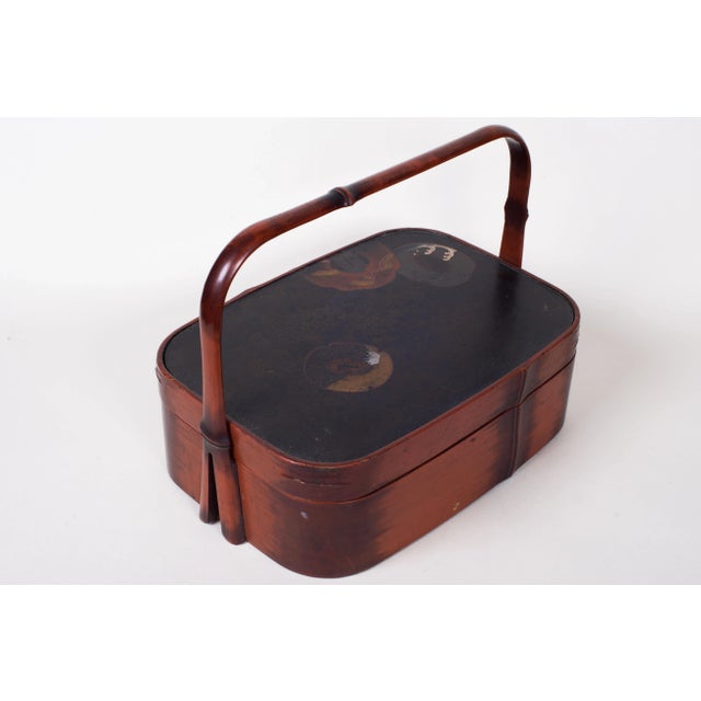 Antique Japanese Lacquered Handled Box with Tsuba Motif. Cover depicts three tsubas with silver and gilt accents....