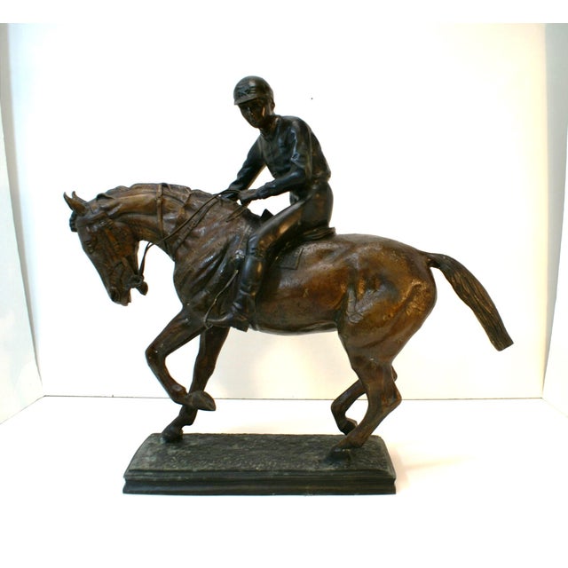 Classic Large Jockey riding a racehorse with tack. Great two-tone finish, the rider is a darker bronze and the horse has a...