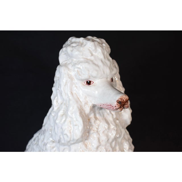 An elegant Mid 20th Century studio pottery poodle fully hand crafted with sculpted, painted and glazed detailing....