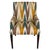 A pair of accent chairs upholstered in a vibrant multicolor ikat fabric from Lee Jofa. The chairs showcase clean lines,...