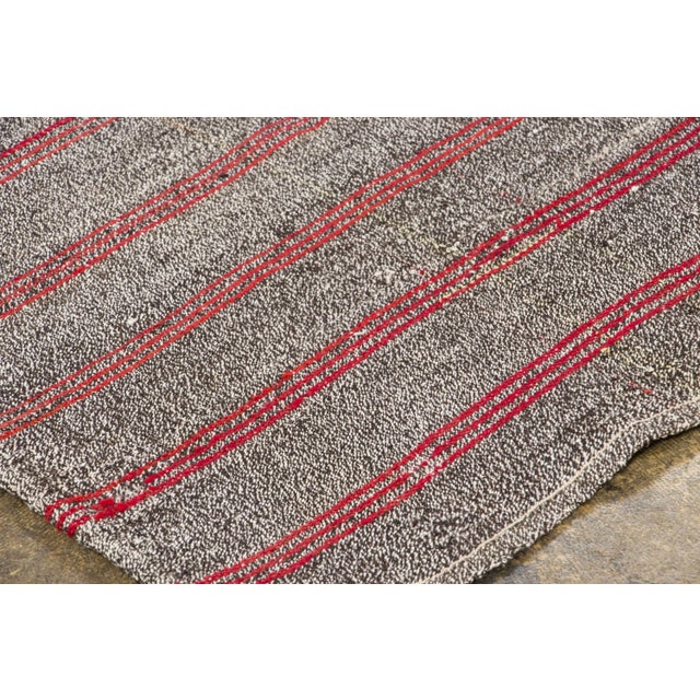 Handwoven in pure goat hair and originating circa 1950-1959, this 7x8 vintage Turkish kilim rug joins Rug & Kilim’s Kilim...