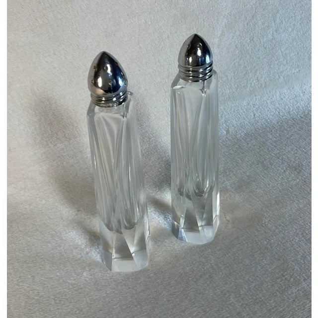 Tall fine angular cut crystal salt and pepper shakers with chrome screw tops. Very clean (not foggy) elegant and sleek in...